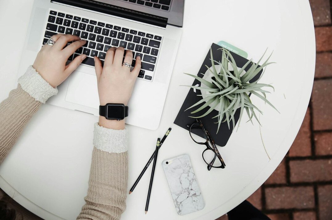 person prioritizing tasks on laptop